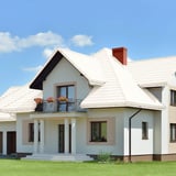 Dach mit Pfannenblech Szafir 350/15 in Reinweiß RAL 9010 auf einem Wohnhaus mit Balkon