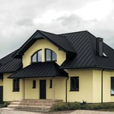 Wohnhaus mit anthrazitgrauem Stehfalzblech PD-510-S und Eingangsueberdachung