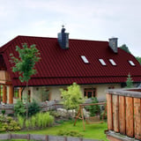 Stehfalzblech PD-510-S weinrot auf einem Wohnhaus mit mehreren Dachfenstern