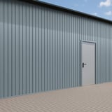 Trapezblech T7M Fehgrau als Wandverkleidung an einem Gebaeude mit Tuer