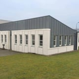 Wellblech 18/1064 Reinweiß (RAL 9010) als Fassadenverkleidung an einem Buero- oder Industriegebaeude