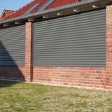 Wandverkleidung aus Wellblech 18/1064 Graualuminium, Stahl 0,50 mm, 25 µm Polyesterbeschichtung, an Ziegelmauer