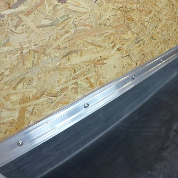 Fertig montierte Metallschiene mit Schrauben ueber dem schwarzen Anschlusskleber Flex auf Dachfolie