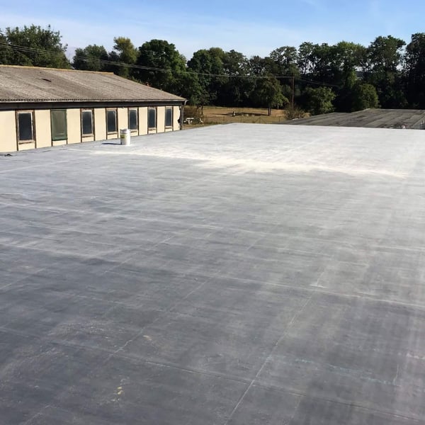 Großflächig verlegte schwarze EPDM Dachfolie auf einem Industriedach