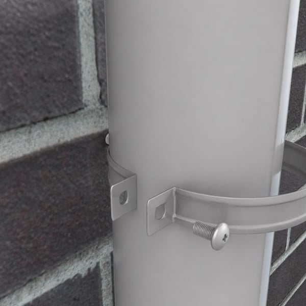 Detailansicht einer Fallrohrschelle in Graualuminium, die ein Fallrohr an einer Ziegelwand haelt