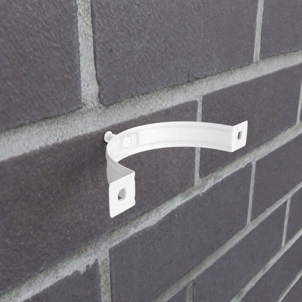 Reinweiße Fallrohrschelle aus Stahl an einer dunklen Ziegelwand montiert