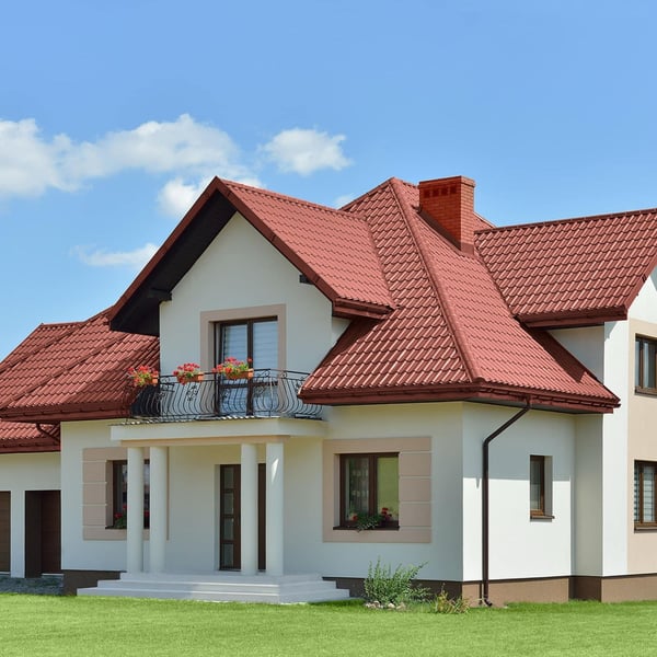 Verlegung von rotbraunem Pfannenblech Szafir 350/15 auf einem Wohnhaus mit Balkon