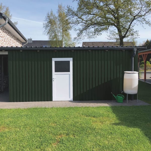 Trapezblech 20/1100 Aluminium Moosgrün als Wandverkleidung einer Garage mit weißer Tür
