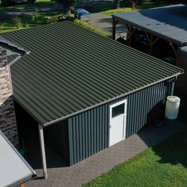 Trapezblech 35/207 Chromoxidgrün auf einem Carport mit angrenzender Garage und Regenwassertonne