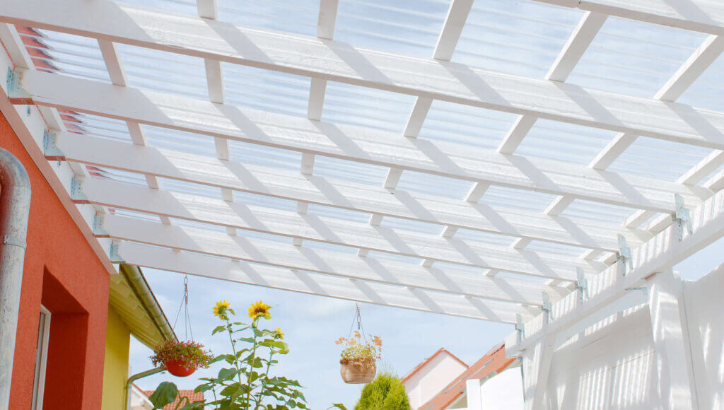 Transparente Wellplatten auf Pergola bieten Schutz und lassen natürliches Licht durch.